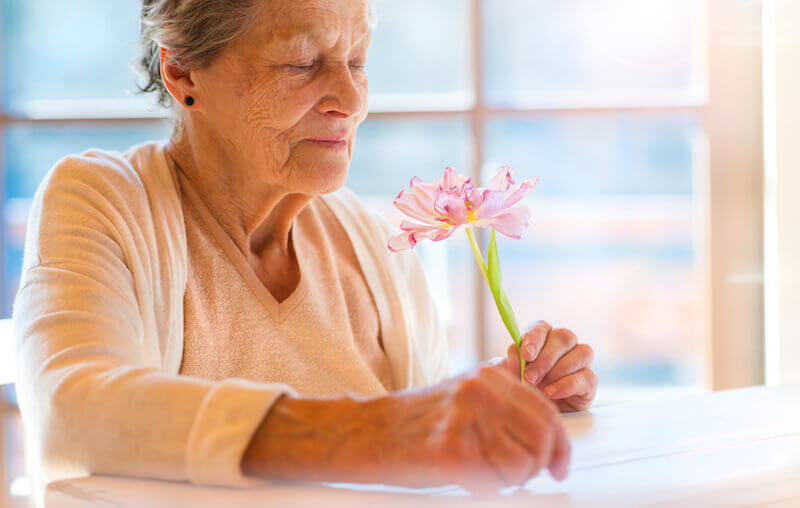 Charitoo showing an old woman with flowers