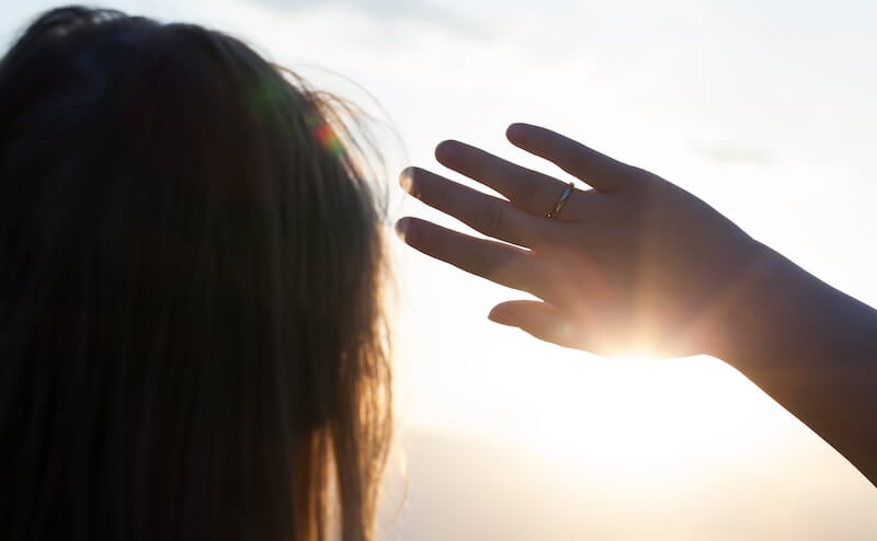 God who hides Himself showing a man looking at the light