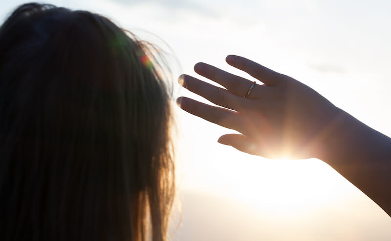 God who hides Himself showing a man looking at the light