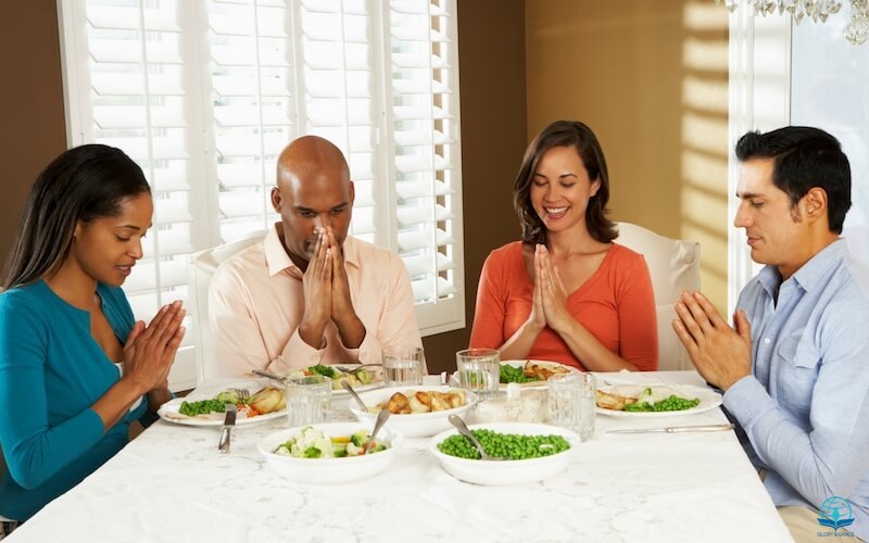 Grace in the Book of Ephesians image showing a group of black and white people on a dinner table