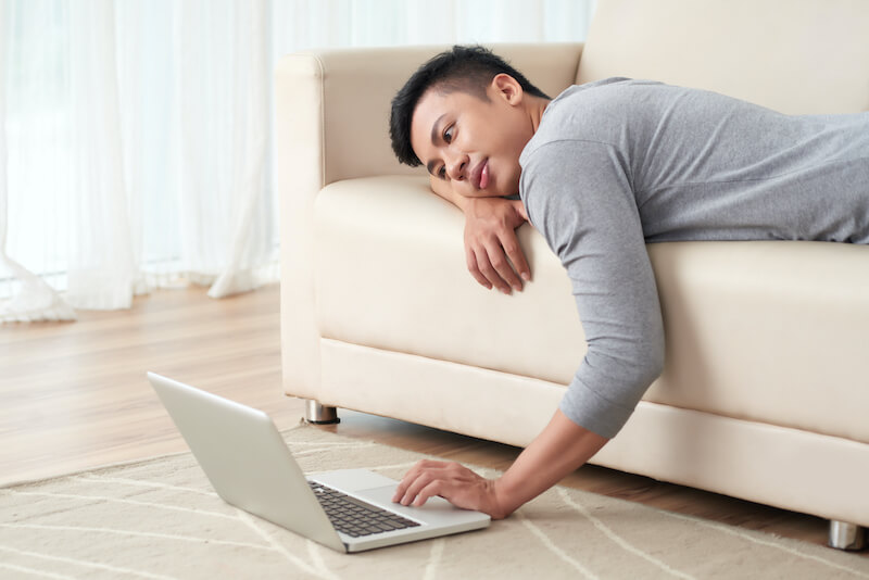 How long will you sleep, O sluggard? showing a man laying down to sleep