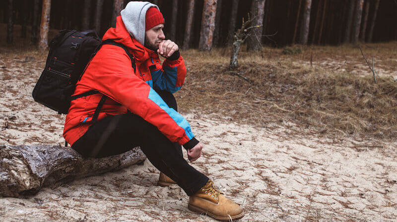 The LORD has given you rest from your pain and turmoil showing a hiker resting