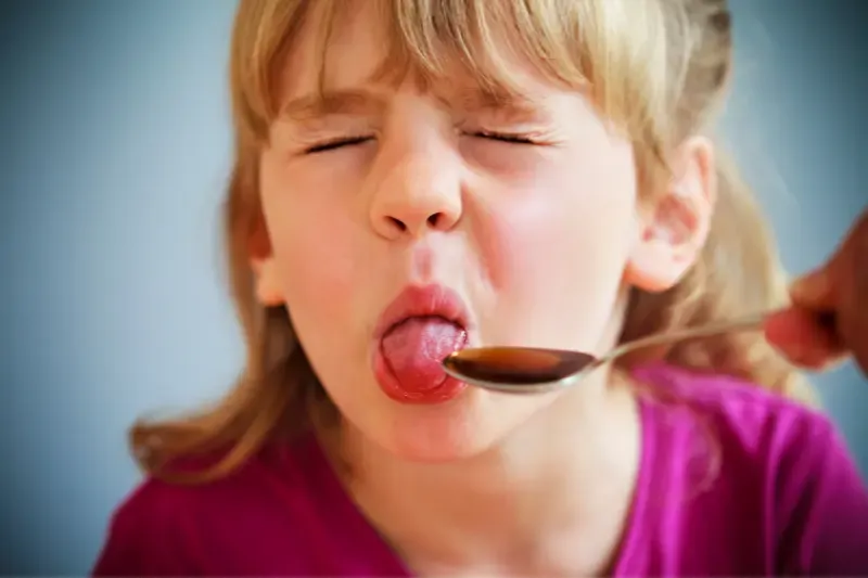 bitterness begets bitterness showing a child taking a bitter pill