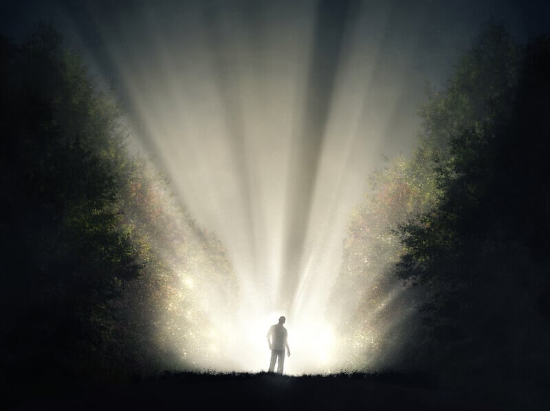 Christ the Power of God, and the Wisdom of God showing a man with light in the forest