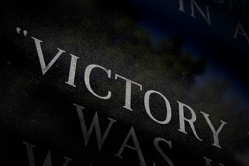victory showing the letters of the word in a dark background