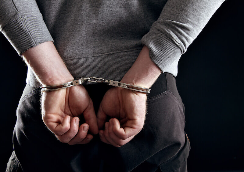 forgetting those things that are behind showing a man in handcuffs