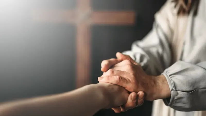 Grace is partaking in the Son of God showing Jesus holding our hands