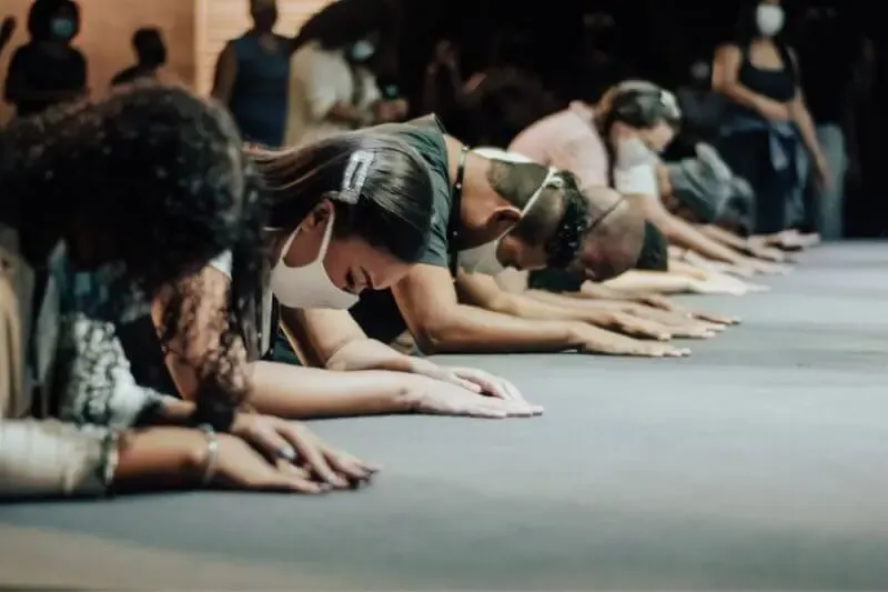 Holistic worship showing believers falling down to worship