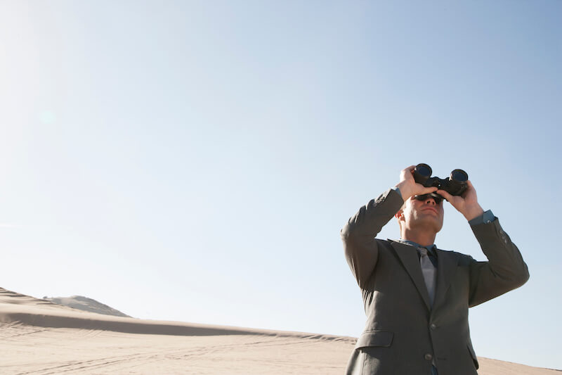 beholding the glory of God showing a man looking through a magnifying glass