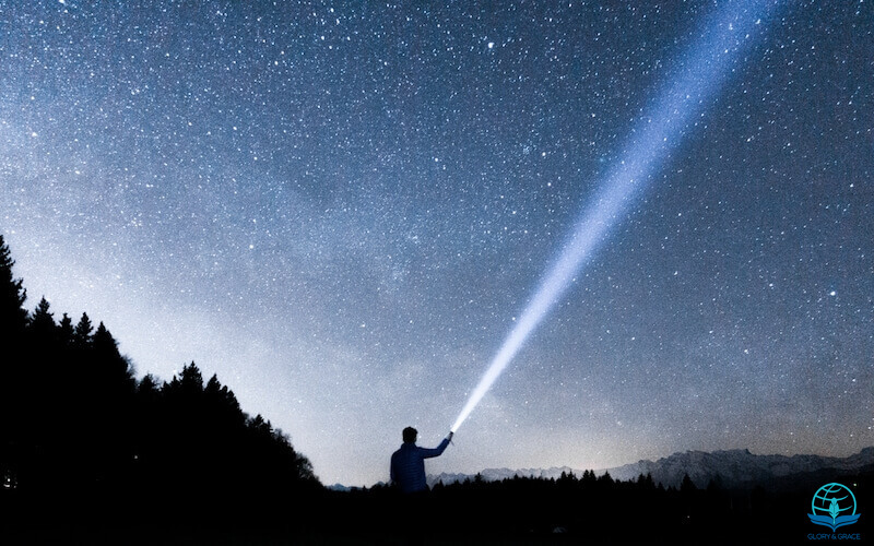In the twinkling of an eye showing a man with a bright torch in a starry night