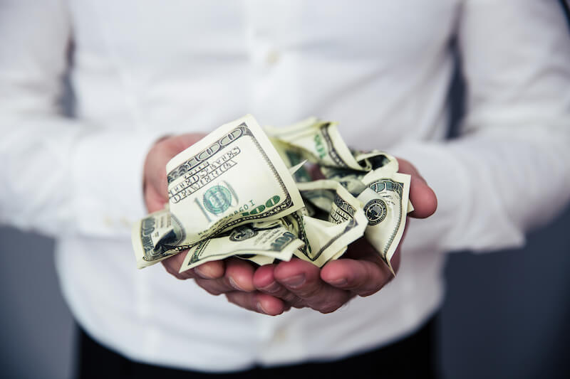 money increase showing dollars in the hands of a man