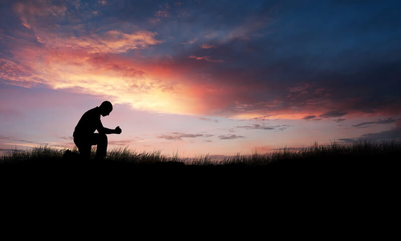 prayer of paul showing a man kneeling down