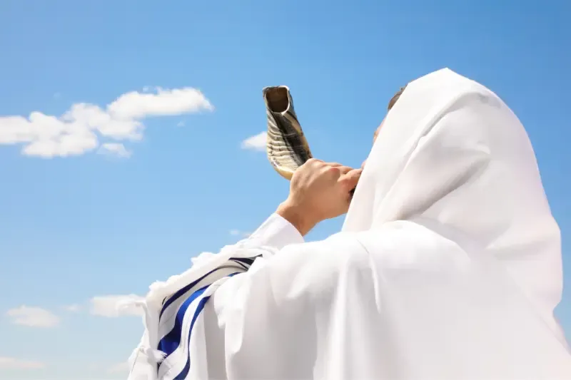 three major jewish feasts showing a man blowing a shofar