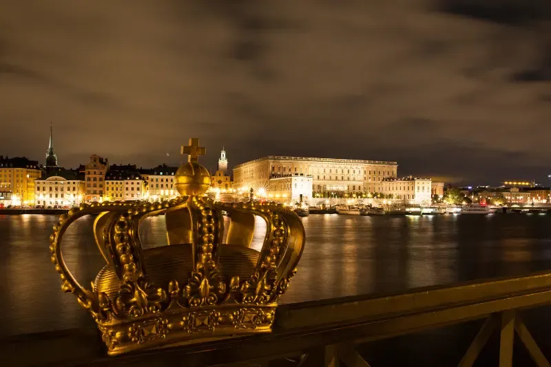 thy kingdom come showing a crown overlaid on a city