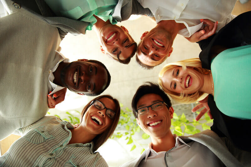 unity of the Spirit in the bond of peace showing people putting heads together