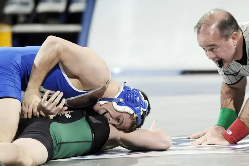 wrestling in prayer showing two wrestlers fighting